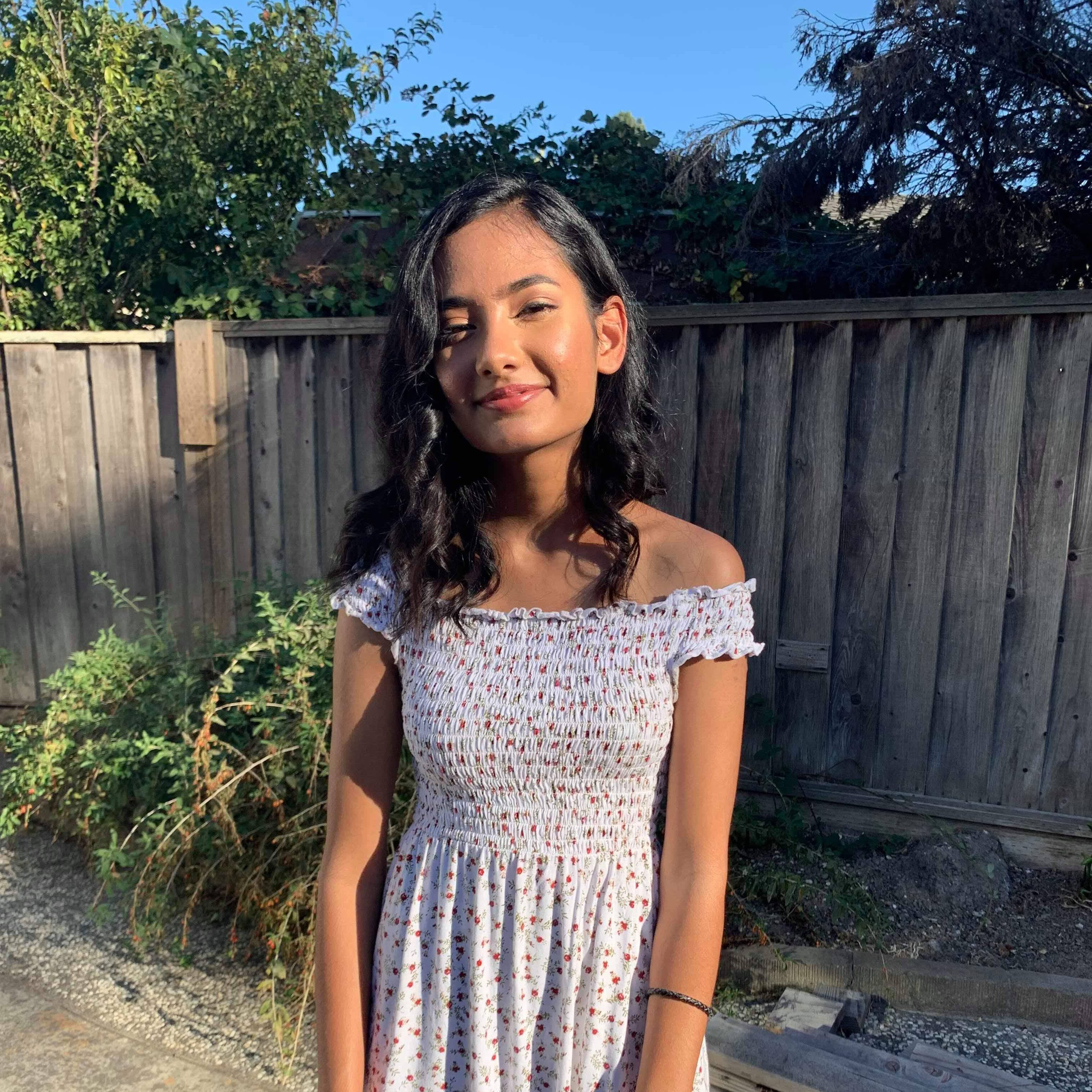 archie in a dress in a backyard