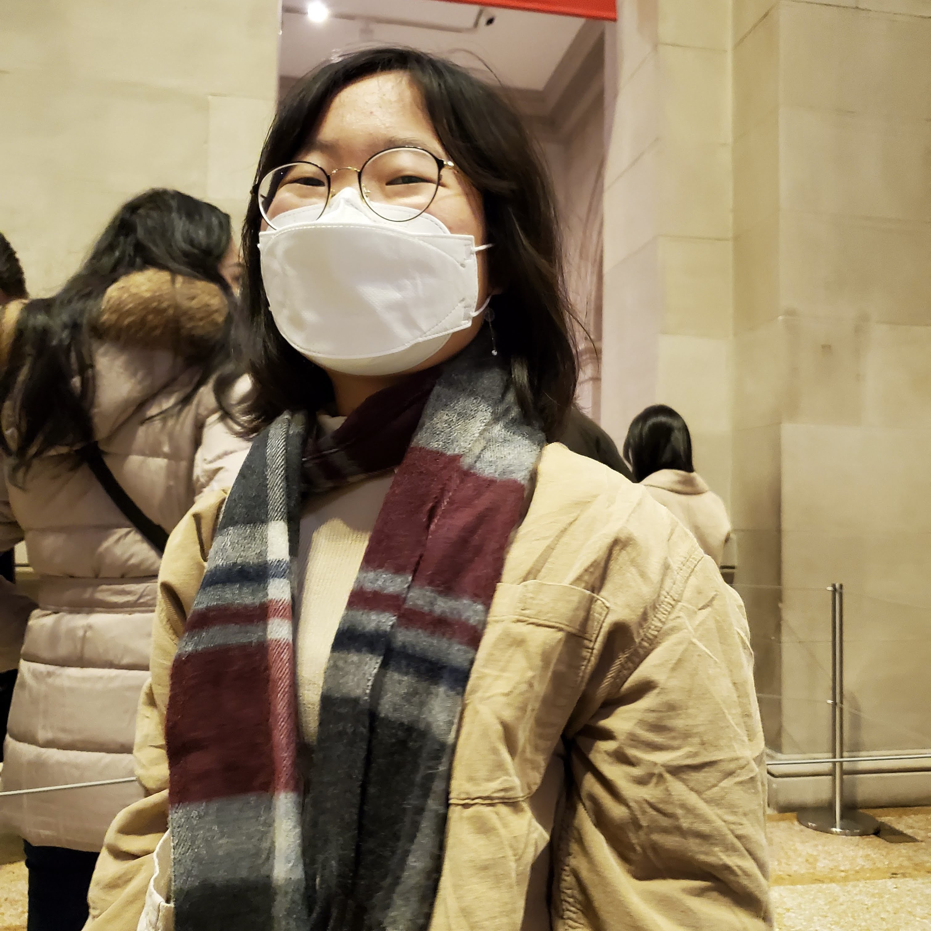 christine wearing a scarf and smiling at the camera