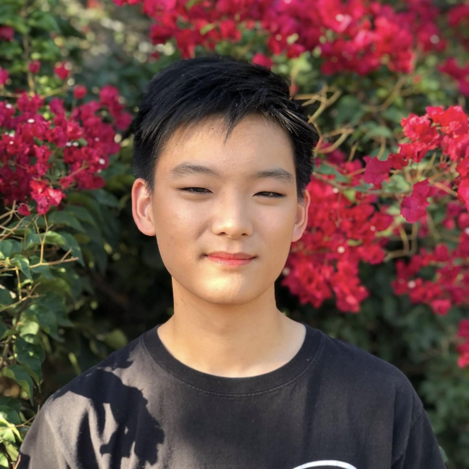 edmond in front of some flowers