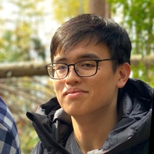 Charles standing in front of trees