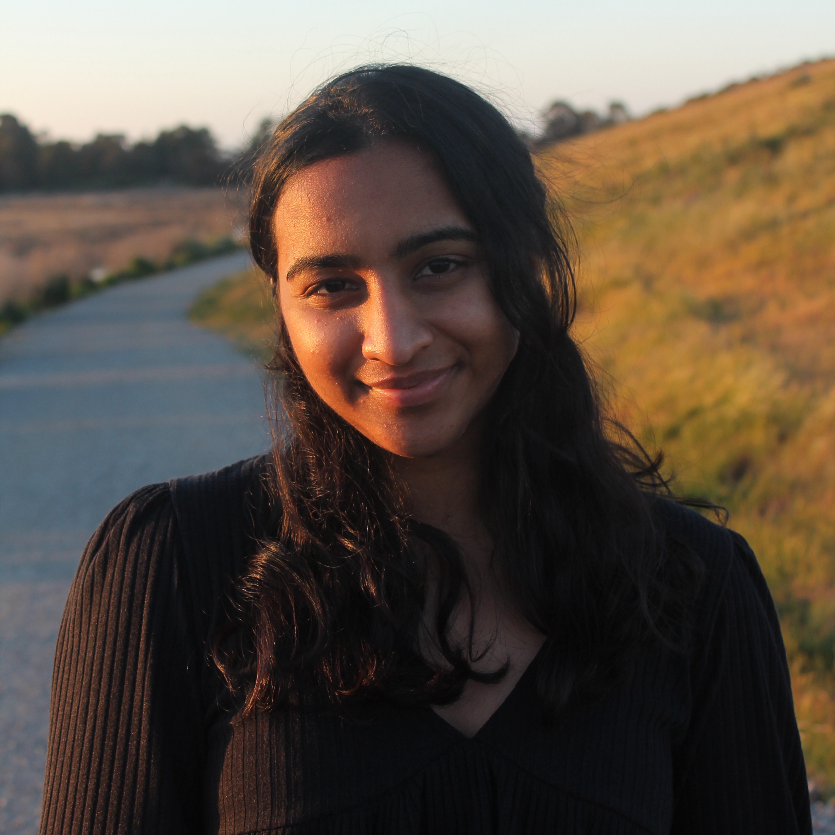 Isha smiling while standing on a road