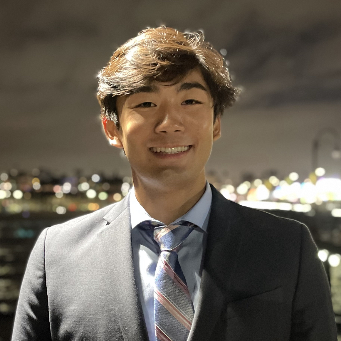 Jason smiling in a suit