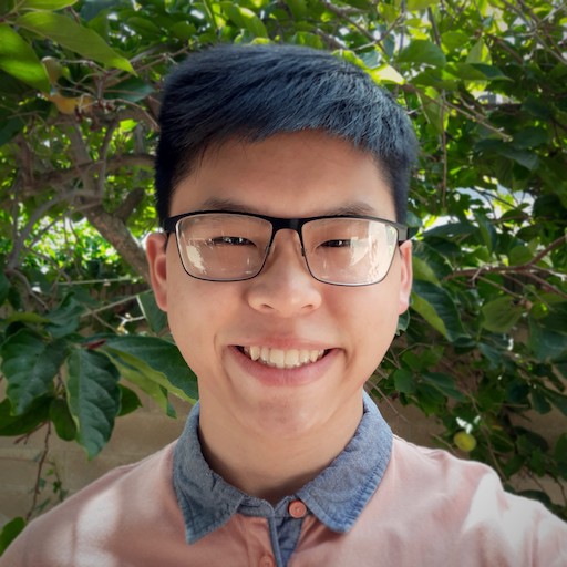 a photo of jason smiling in front of some plants