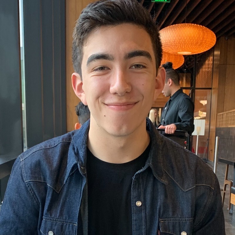 Jeremy smiling while sitting in a restaurant