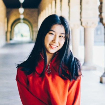 Julia standing in a hallway with pillars